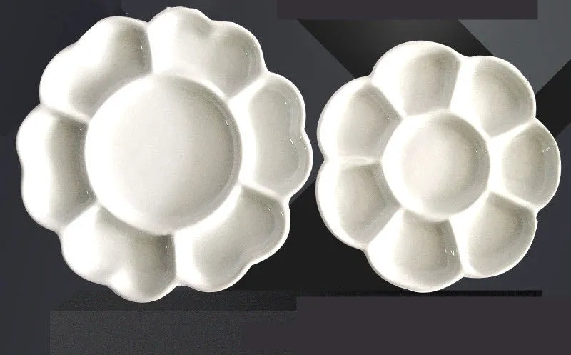 White hand-made ceramic plum blossom shaped artist palette for paint mixing.