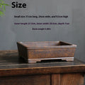 Handmade rectangular purple sand bonsai pot with natural firewood-burnt glaze, shown empty on a wooden surface.