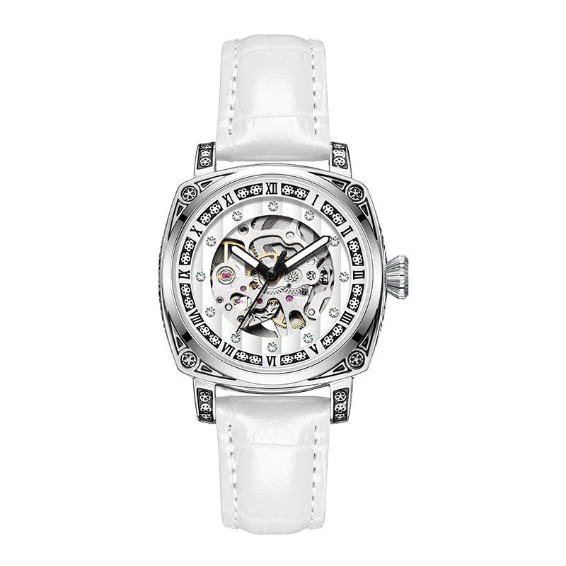 Men's black leather strap mechanical watch with luminous hands on a wrist.