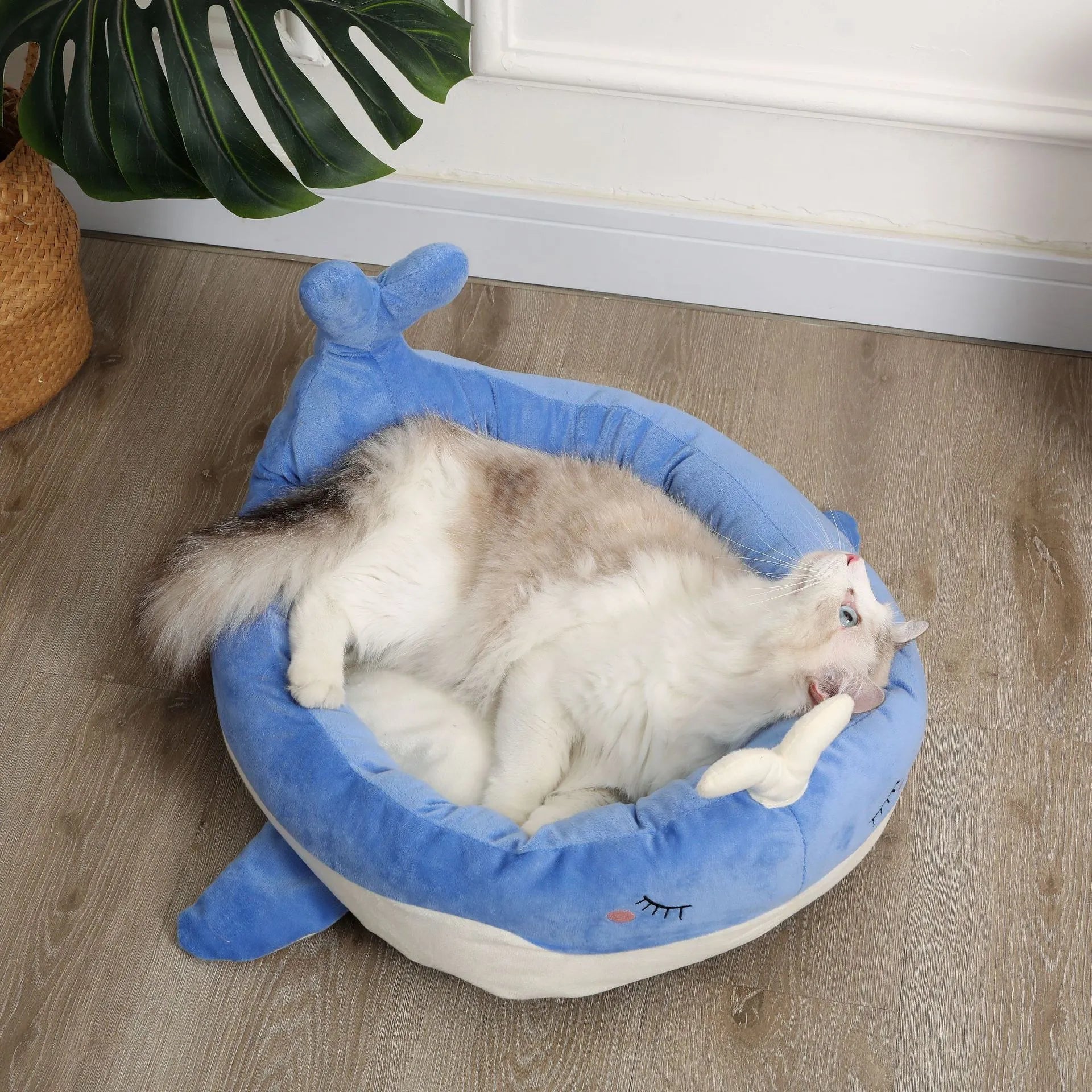 Blue duck-shaped fluffy pet bed sofa for small dogs and cats on wooden floor