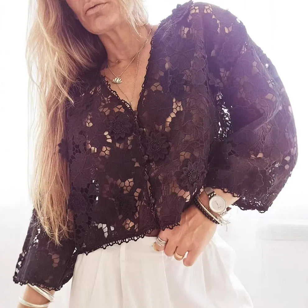Women's black V-neck lace shirt with white three-dimensional flower decoration and long sleeves.