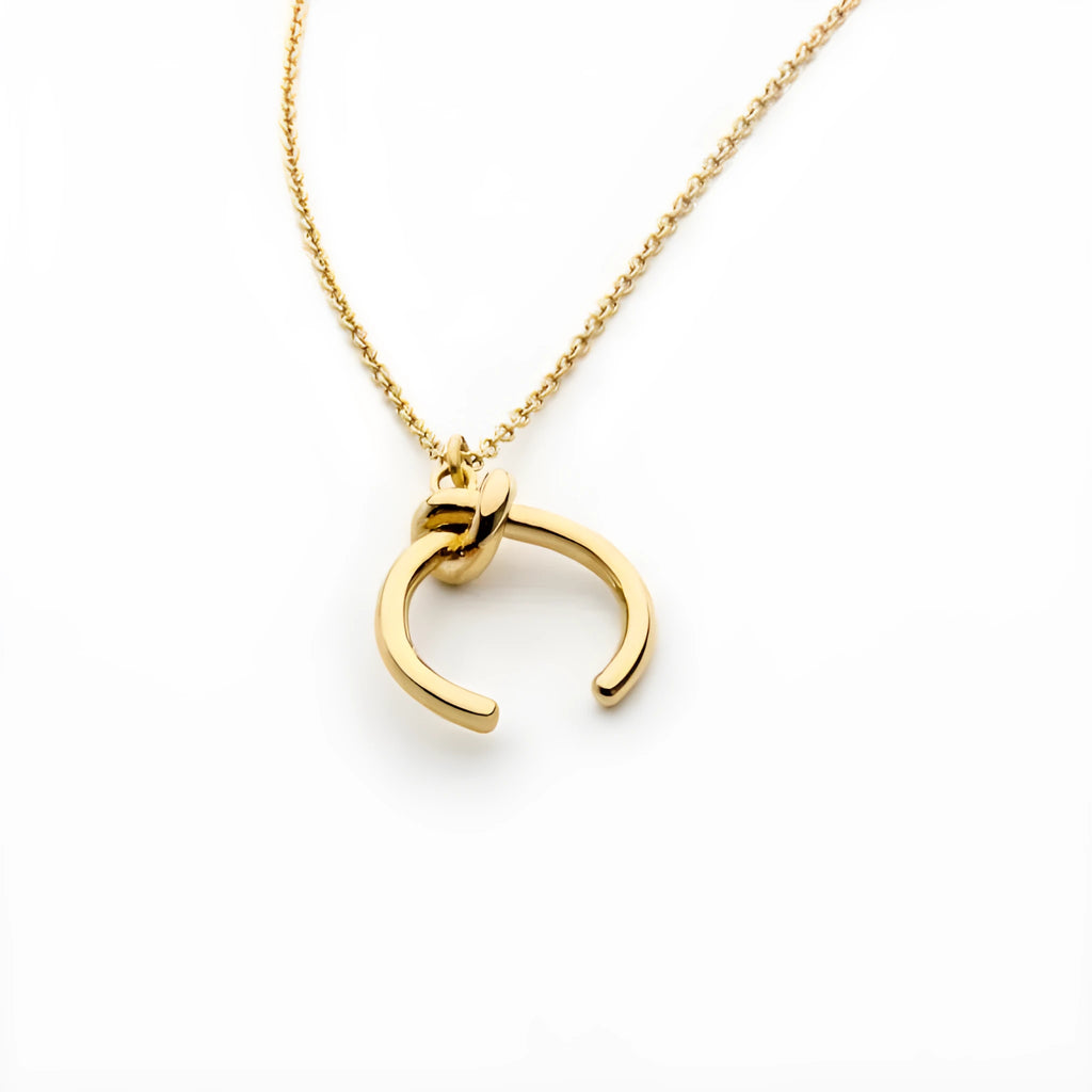 Vintage-style geometric copper pendant necklace on an adjustable cross chain in gold colour.