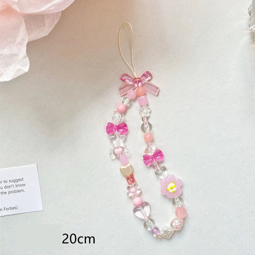 Blue, pink, and yellow floral beaded phone lanyard with plastic resin charms.