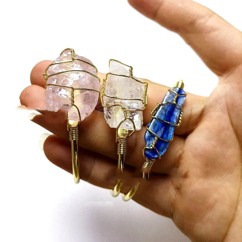 Unisex geometric bracelet made from rough natural crystals with gold metal winding.