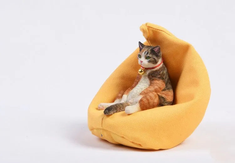 Lazy cat car ornament figure on fabric sofa, 7.5cm high resin model decoration.