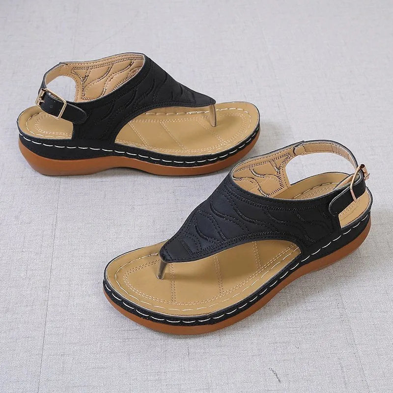 Women's black casual wedge heel flip flop sandals with an adjustable buckle strap.