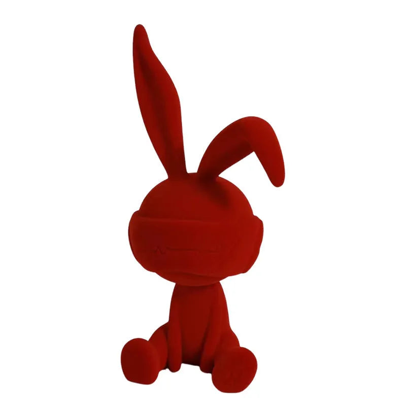 Green suede-finish resin ornament of a blindfolded rabbit for table decoration.