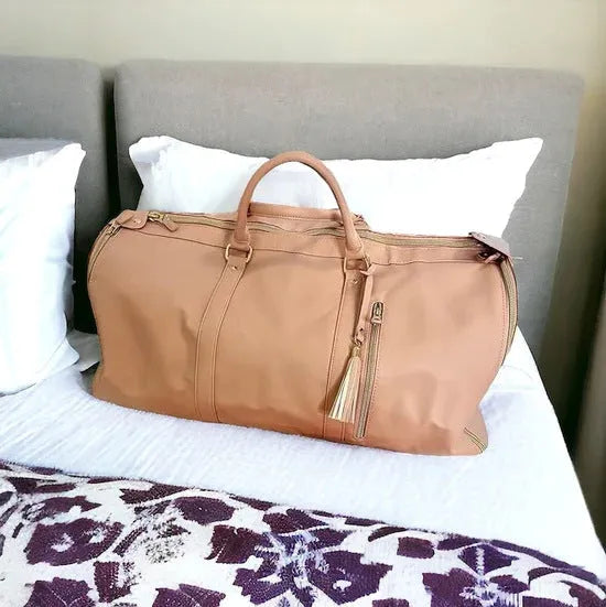 Waterproof PU leather travel bag in pink, one-shoulder crossbody design, 52x25x32cm, 20-35L capacity