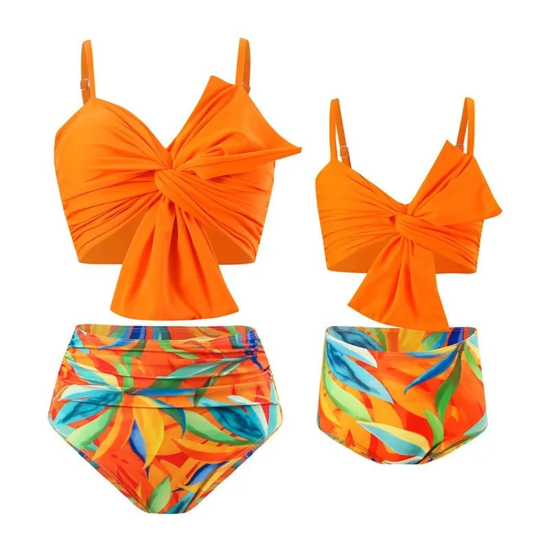 Women's big bow print bikini swim trunks set in bright colours on a mannequin.