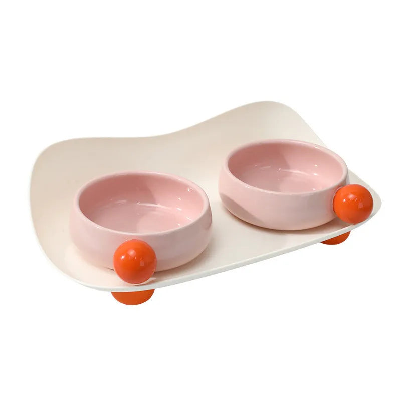 Ceramic raised double bowl set for pet food and water with a non-slip base in yellow.