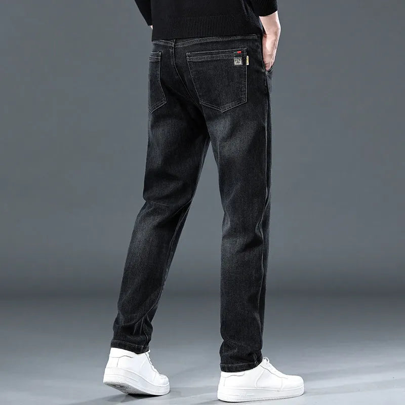 Man wearing blue-grey slim straight loose fit casual trousers with a micro-elastic waist.