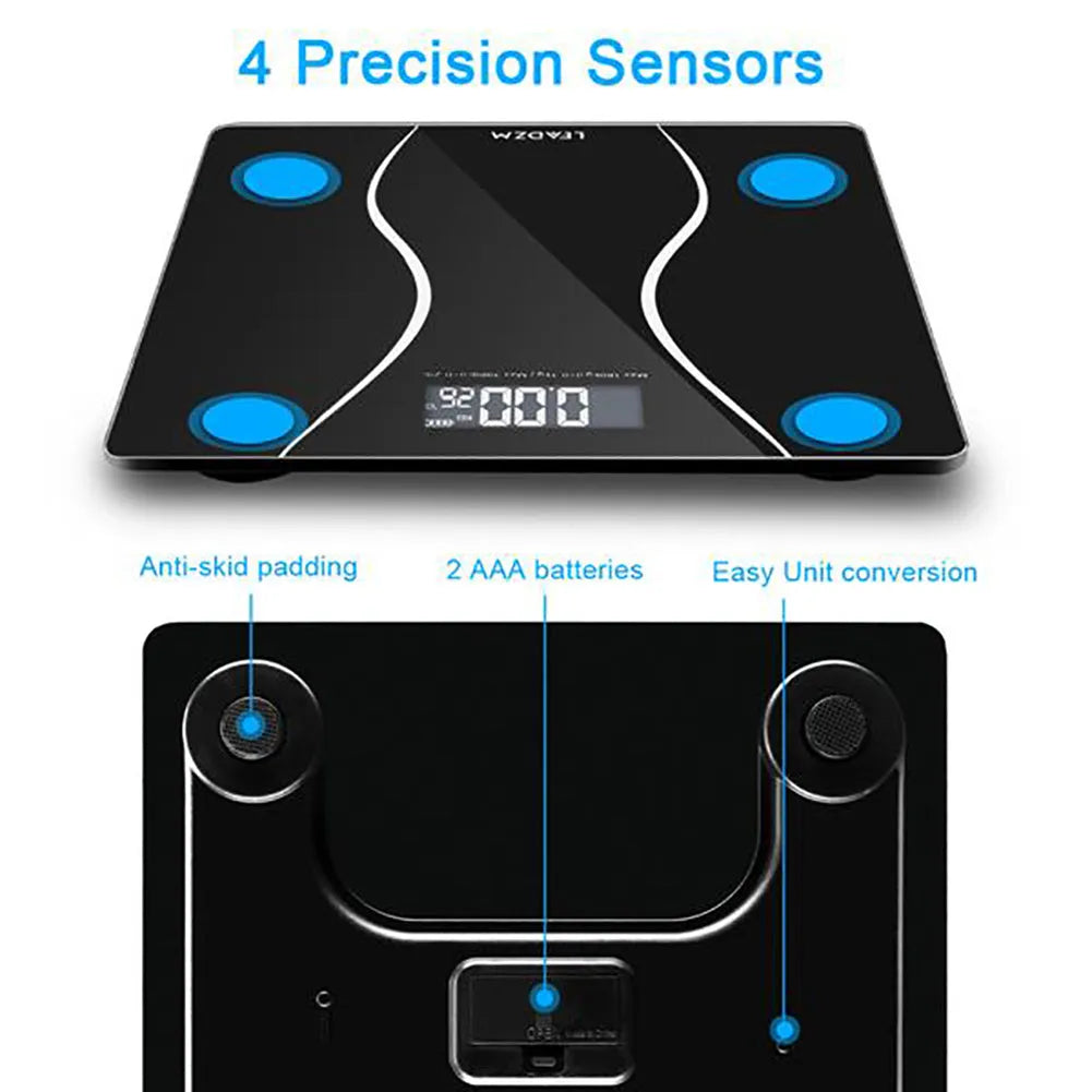 Black electronic digital body scale on a floor, showing a weight readout.