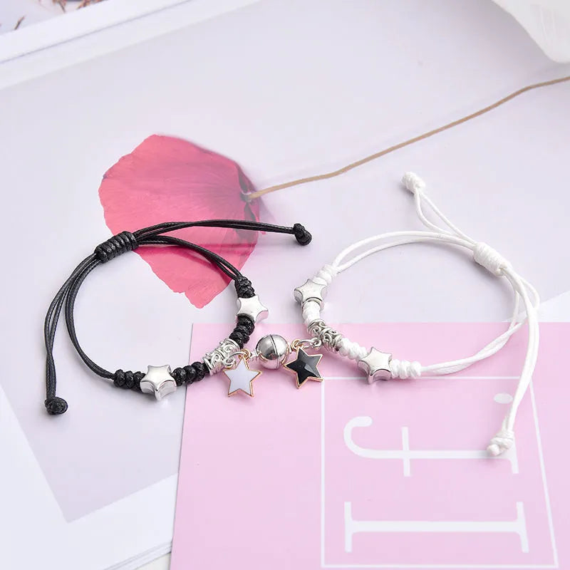 Magnet suction couple bracelets with alloy construction and various pendant designs including crowns and hearts