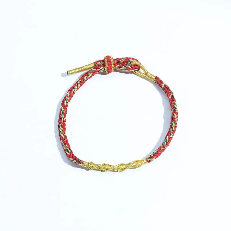 Close-up of an adjustable eight-strand woven hand strap in a zodiac-themed colour on a wrist.