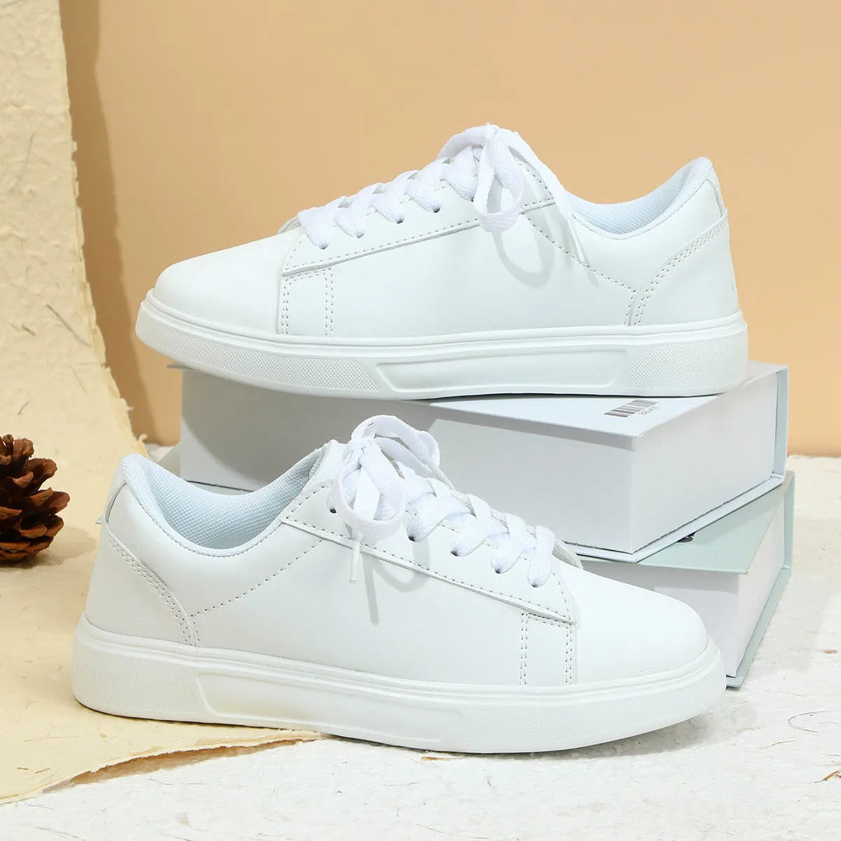 Platform skateboard casual sneaker in beige brown with low top, round toe, and a cross strap detail.