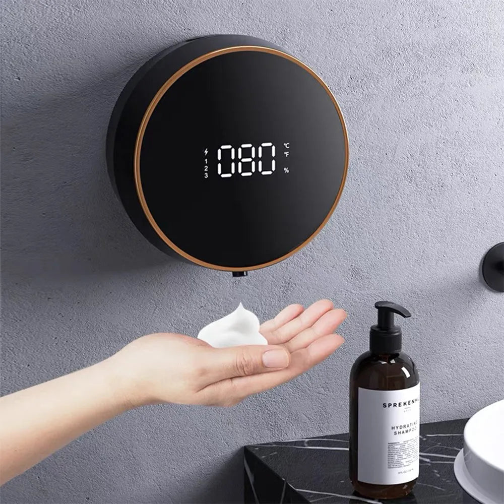 Black automatic sensor foam soap dispenser with USB port mounted on a white bathroom wall.