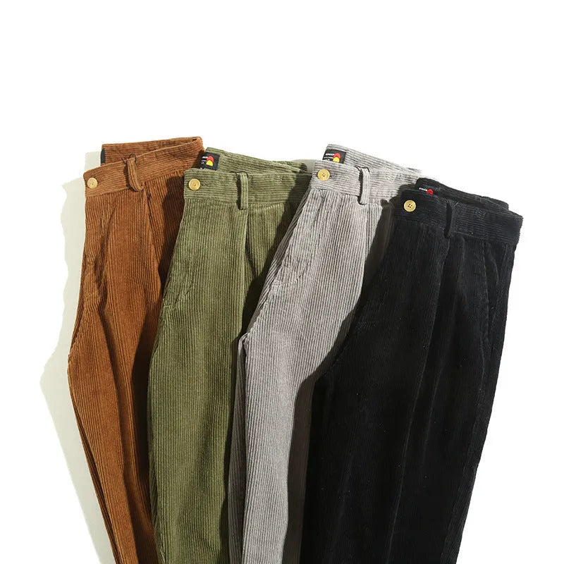 Men's straight-leg corduroy trousers in army green, showing front zipper fly and textured fabric.