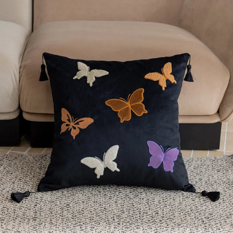 Square beige cushion with colourful embroidered butterfly and Chinese floral pattern.