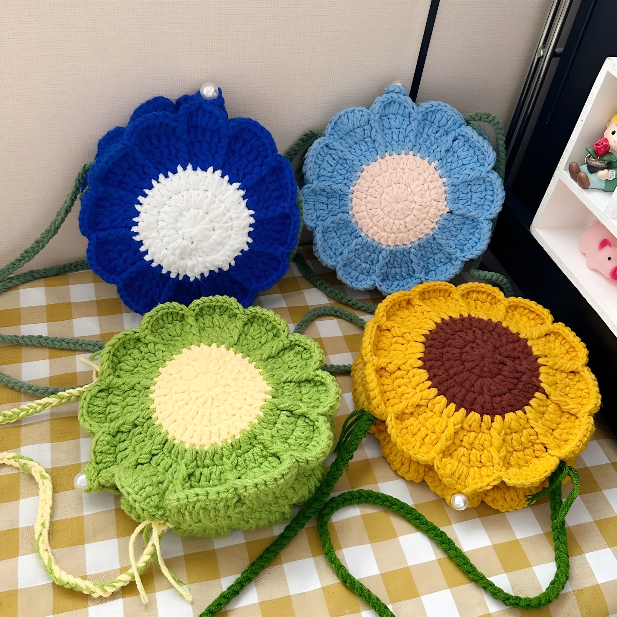 Hand-woven wool bag with crocheted flowers in round shape showing cotton lining and phone pocket