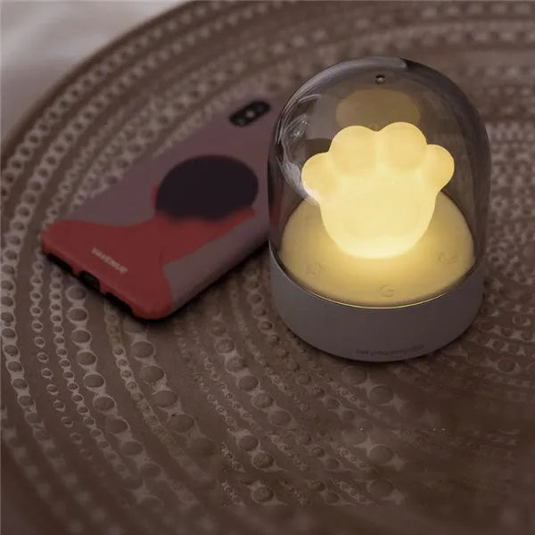 Grey and pink cat paw shaped USB rechargeable night light with rotating dynamic lighting
