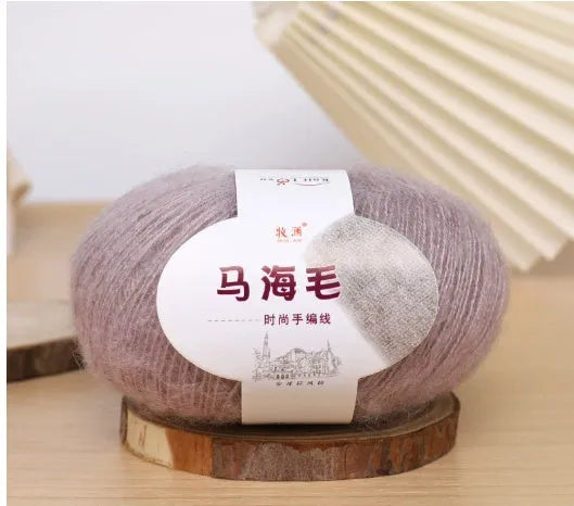 Ball of mohair yarn for DIY scarf knitting in one of 34 colours, including white, pink, blue, and green.