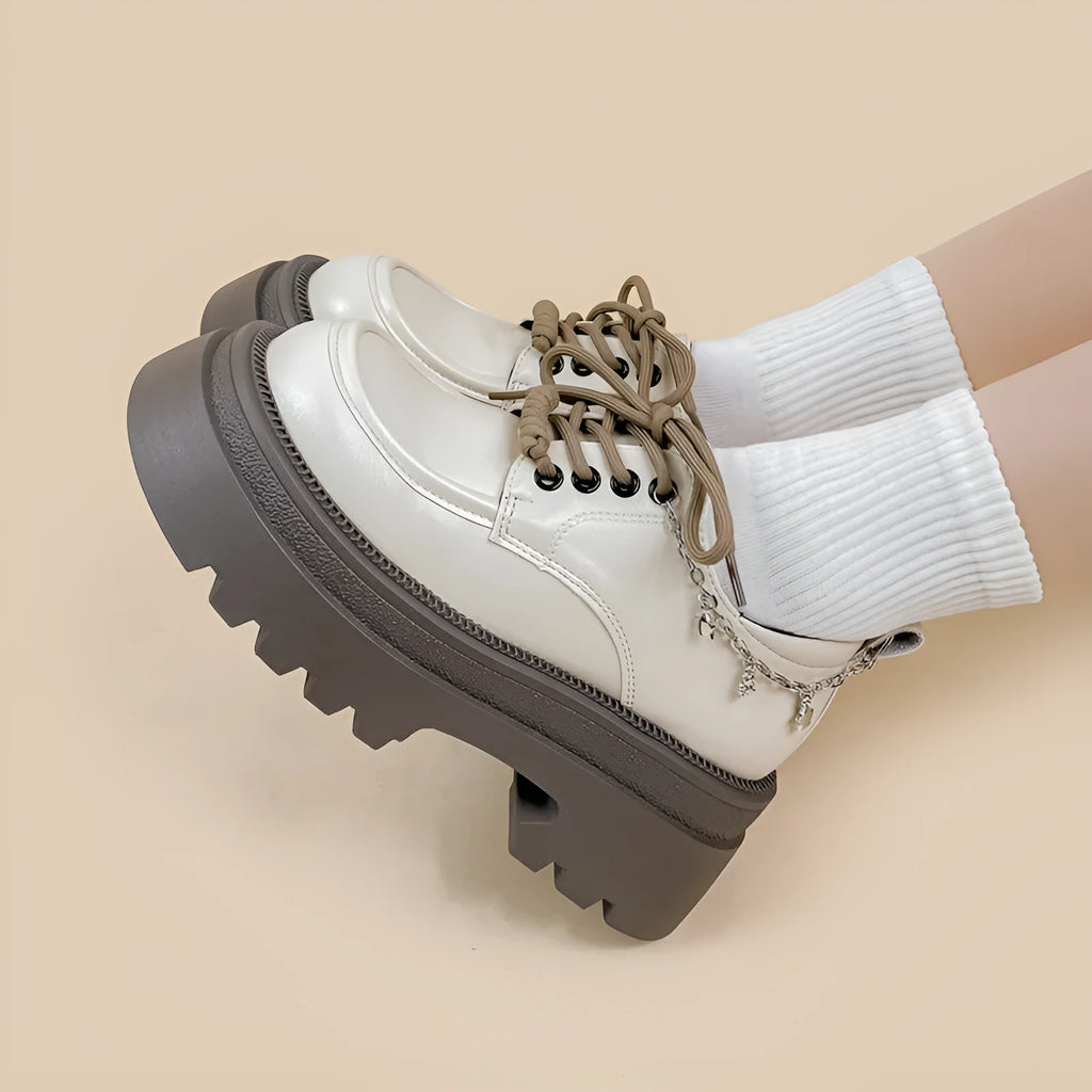 White platform Mary Jane shoes with a chunky block heel and front lace-up detail.