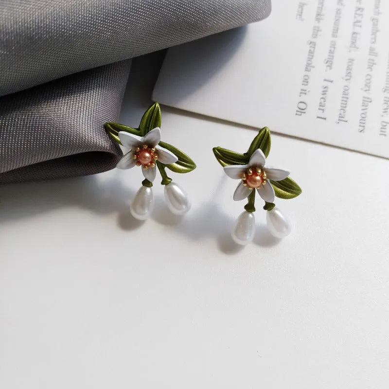 Women's alloy flower earrings showing camellia stud and ear clip options with personality contrast colour
