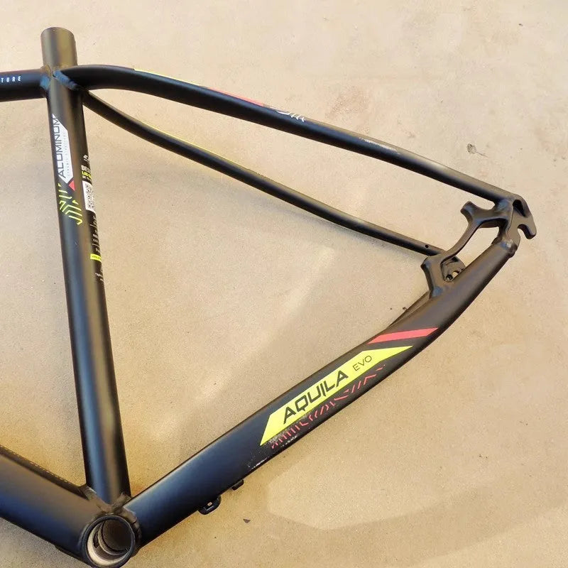 Black green 29-inch aluminium mountain bike frame with disc brake mounts and internal cable routing ports.
