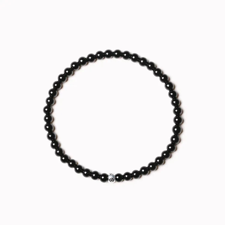 Geometric unisex bracelet with 4mm black agate, blue san, and obsidian beads on a wrist.