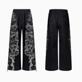 Unisex grey streetwear co-ord set featuring a printed hoodie, loose trousers, and seven-inch shorts laid flat