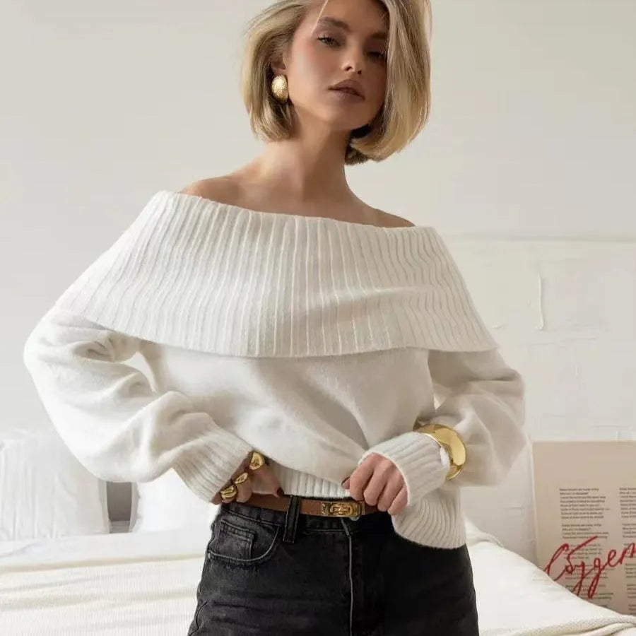 Grey off-the-shoulder sweater with a 3D pattern, shown on a model.