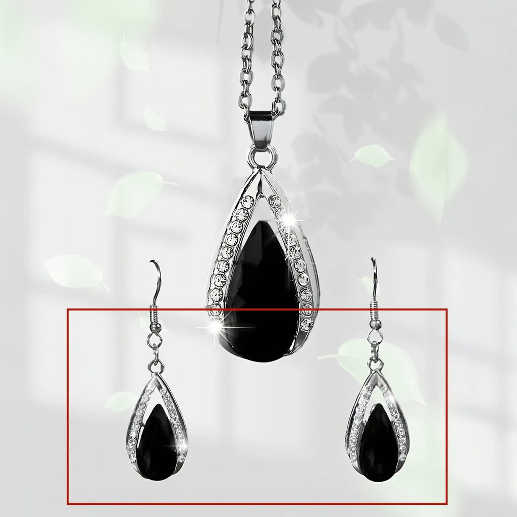 Black and red teardrop glass pendant necklace and matching earrings set on a jewellery display.