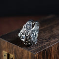 Silver open-ended ring with a raised Domineering Jibeast animal zodiac pattern.