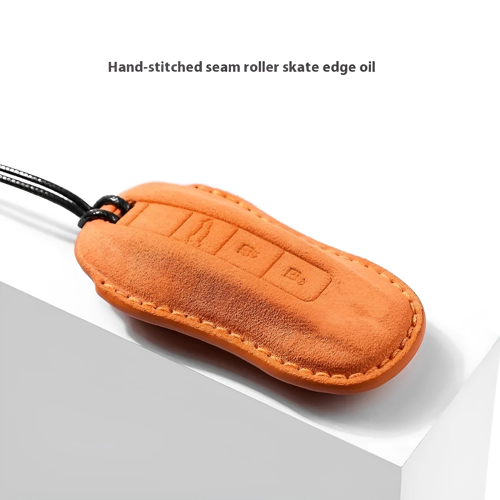 Suede car key cover in cement grey, dark green, light grey, and orange colour options on a plain background.