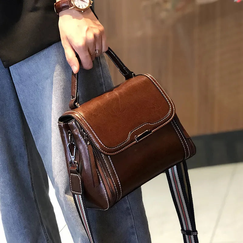 Genuine leather women's vintage messenger bag with multiple internal compartments in caramel colour