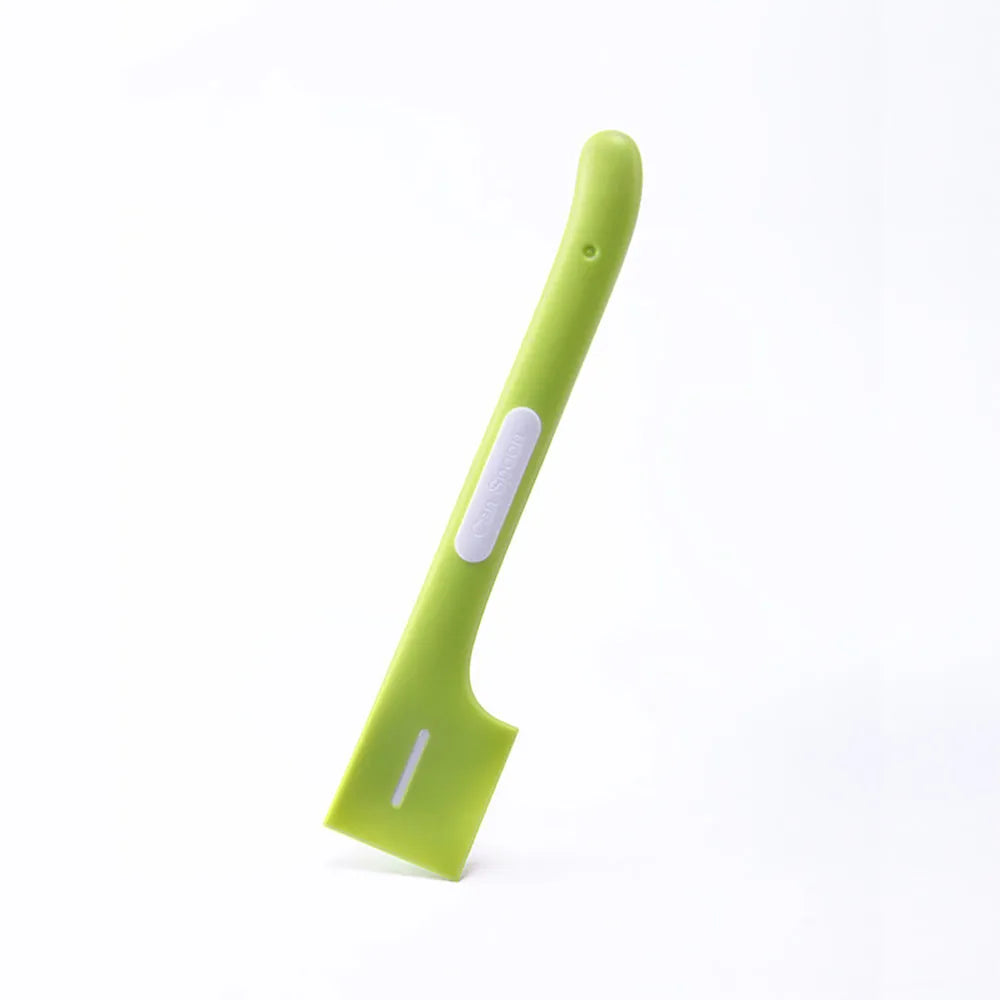 Green long-handled TPR spoon for scooping wet pet food from a tin.