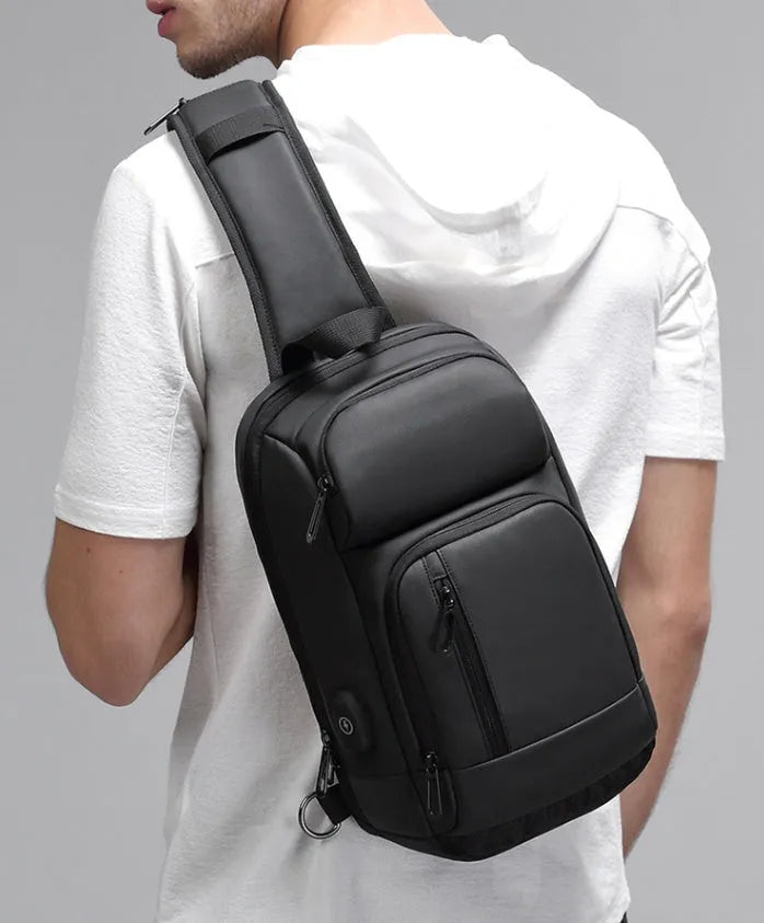 Black medium-sized PVC shoulder bag showing front zipper, air cushion strap, and internal laptop pocket.