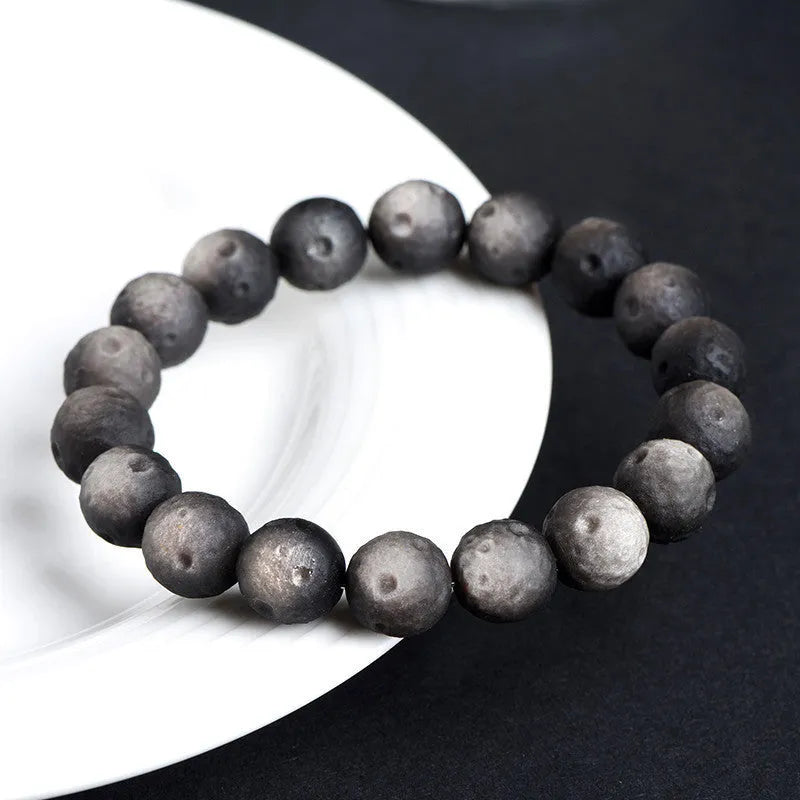 Natural obsidian crater ball bracelet with meteorite texture in silver stone and gold obsidian colour variations