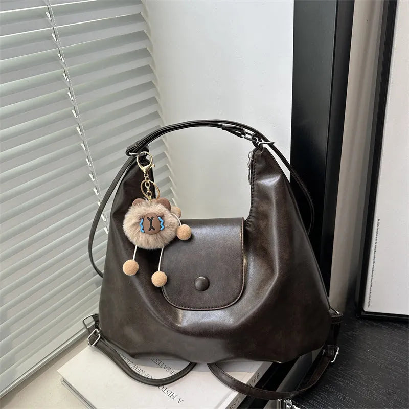 Women's PU leather shoulder bag with single strap, horizontal square design, and internal phone pouch in black colour