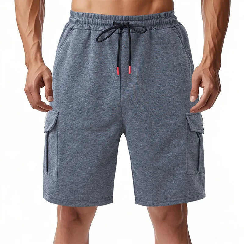 Men's loose-fit grey terry fabric cargo shorts with multiple pockets on a plain background.