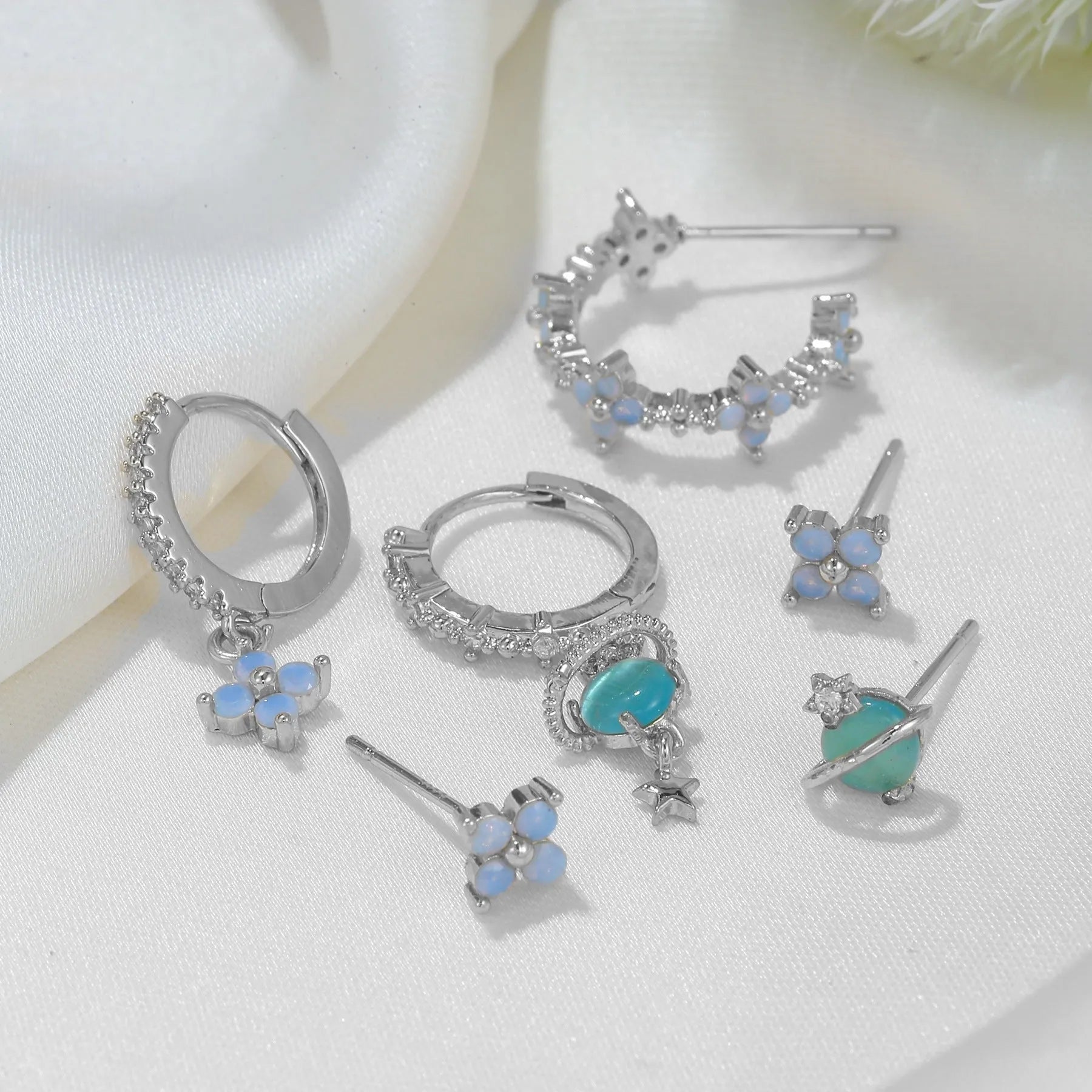 Gold and silver floral ear studs with blue zircon flower nail detail in Japanese Korean style
