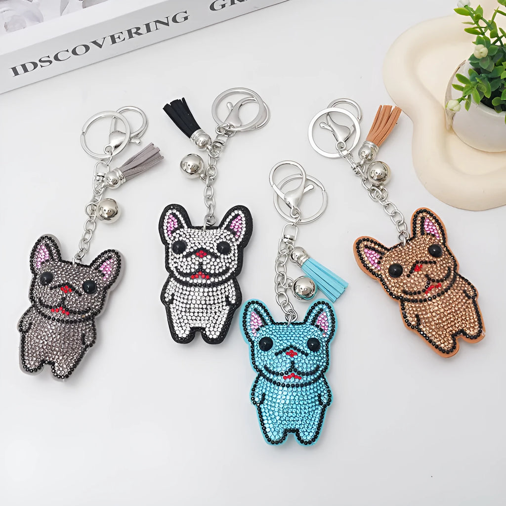 Close-up of a caramel-coloured alloy dog keychain with sparkling clear rhinestones.
