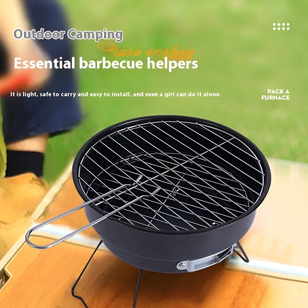Small round metal folding stove with barbecue grill and mesh, set up for outdoor cooking.