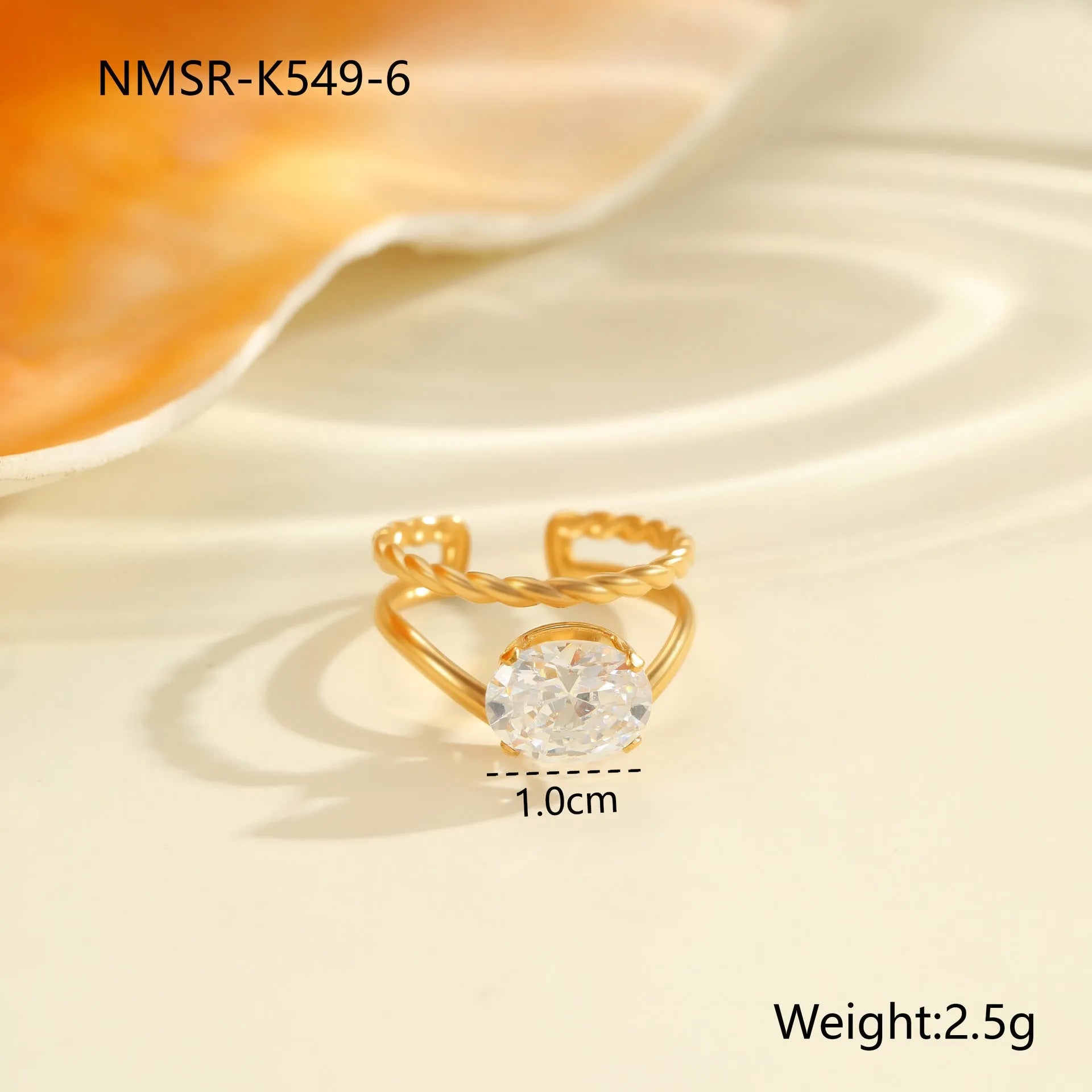 Gold electroplated adjustable ring with geometric zircon design on a stainless steel band.