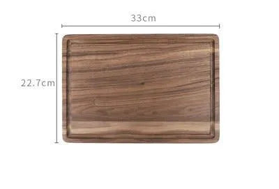 Black walnut wood cutting board set showing rectangular and round boards with juice grooves and side handles