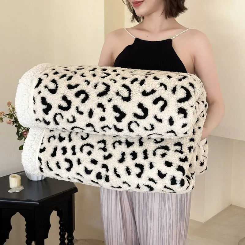 Double-layer cationic leopard jacquard taffeta blanket showing reversible design with zebra pattern