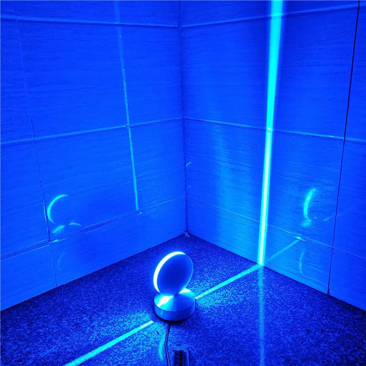 Modern aluminium spotlight bar wall lamp with glass lens, mounted on a wall.