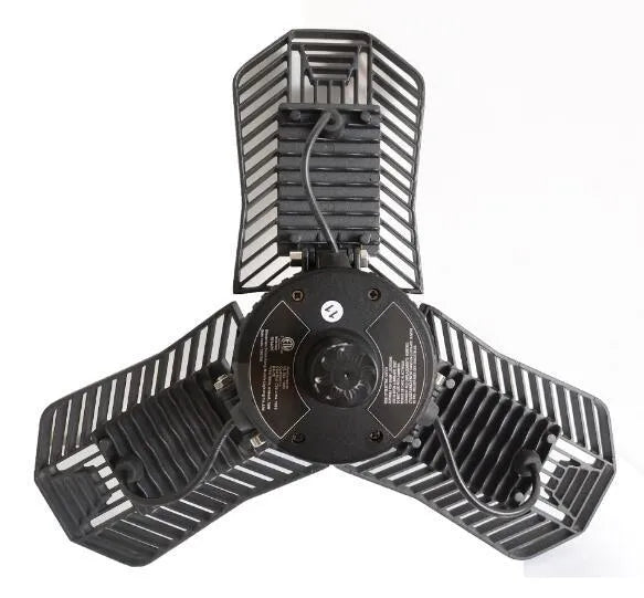 Waterproof foldable industrial garage lamp with die-cast aluminium housing on a workshop bench.