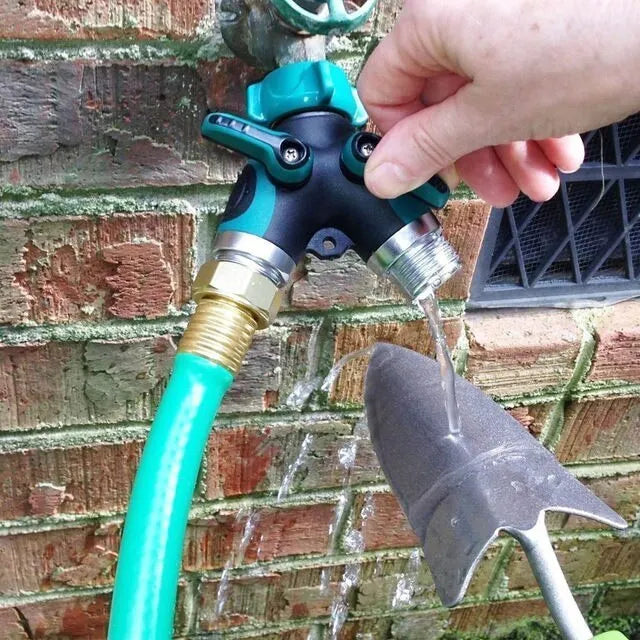 Green plastic Y type double-pass garden hose splitter with two outlets and brass-coloured inlet