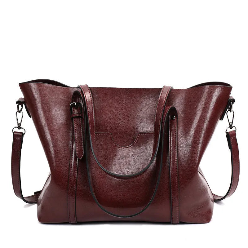 Retro-style brown PU messenger bag for women, shown with an A4 magazine inside to demonstrate capacity.
